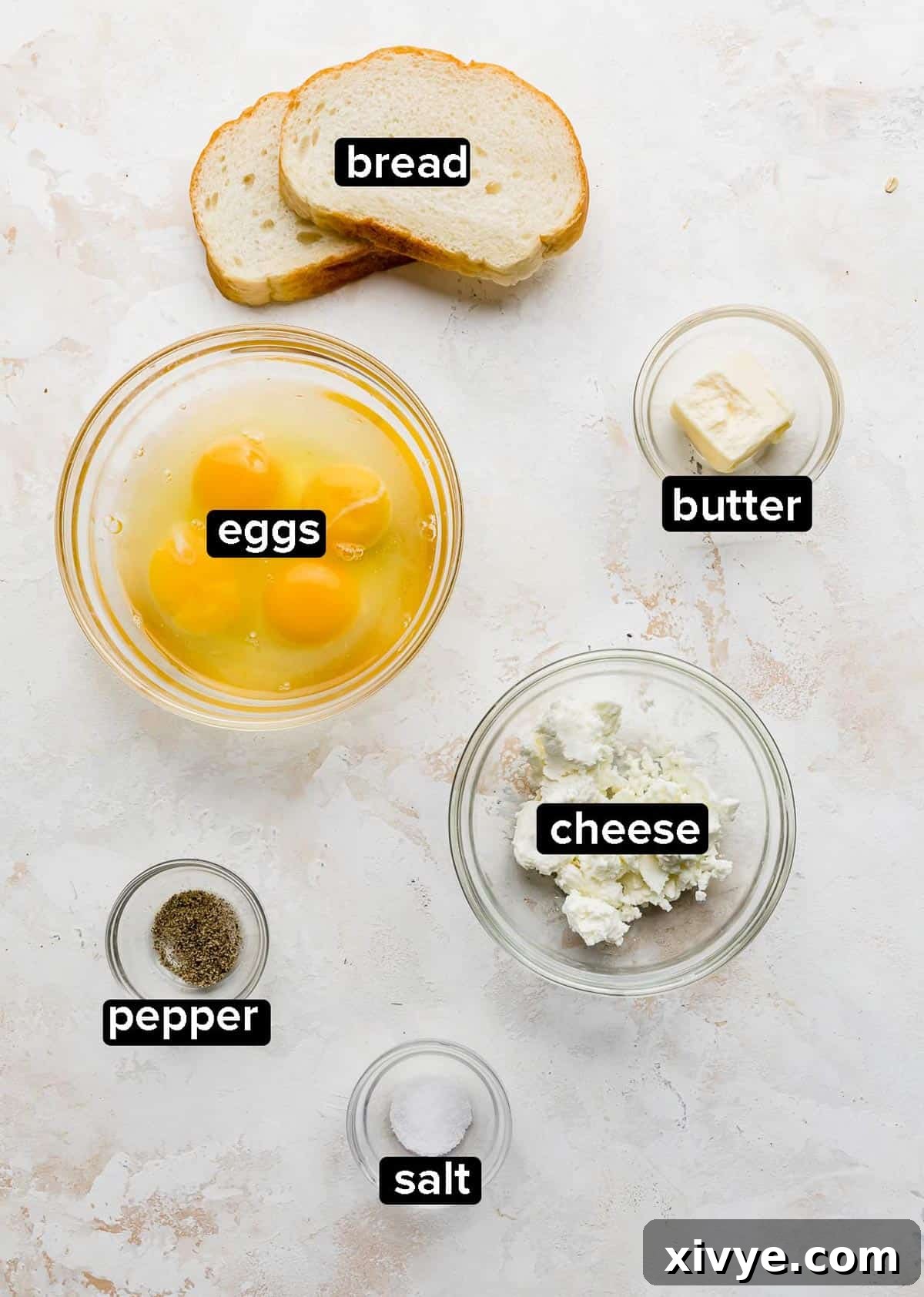 Scrambled Eggs on Toast ingredients on a cream textured background.