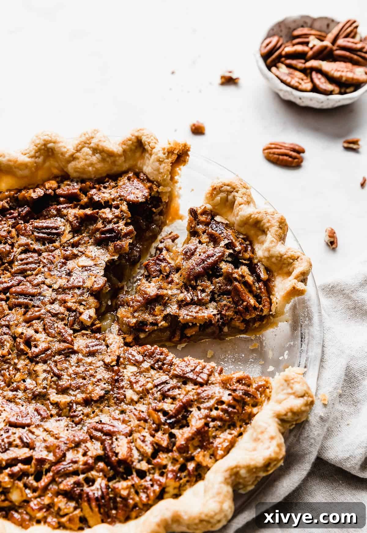 Ultimate Southern Pecan Pie 2 A Southern Pecan Pie Recipe with a slice of pecan pie cut from the whole.