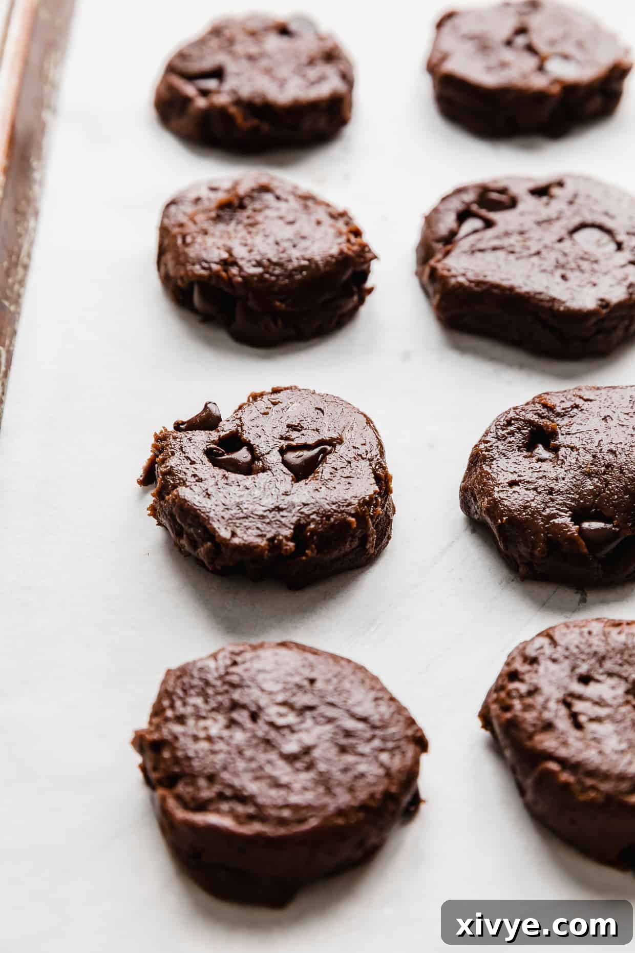 Cookie Ice Cream Delight 6 Flattened double chocolate chip cookie dough on a baking sheet.