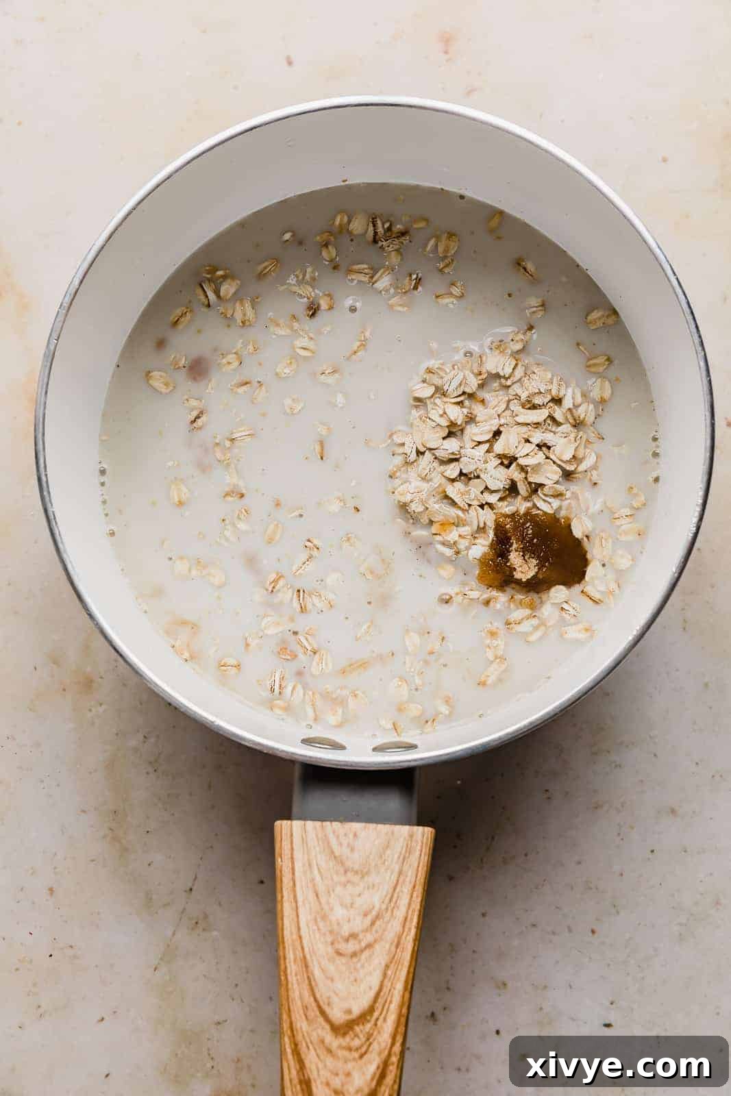 Golden Maple Oat Sweetness 4 A white pot with milk, oats, brown sugar, and vanilla in it.