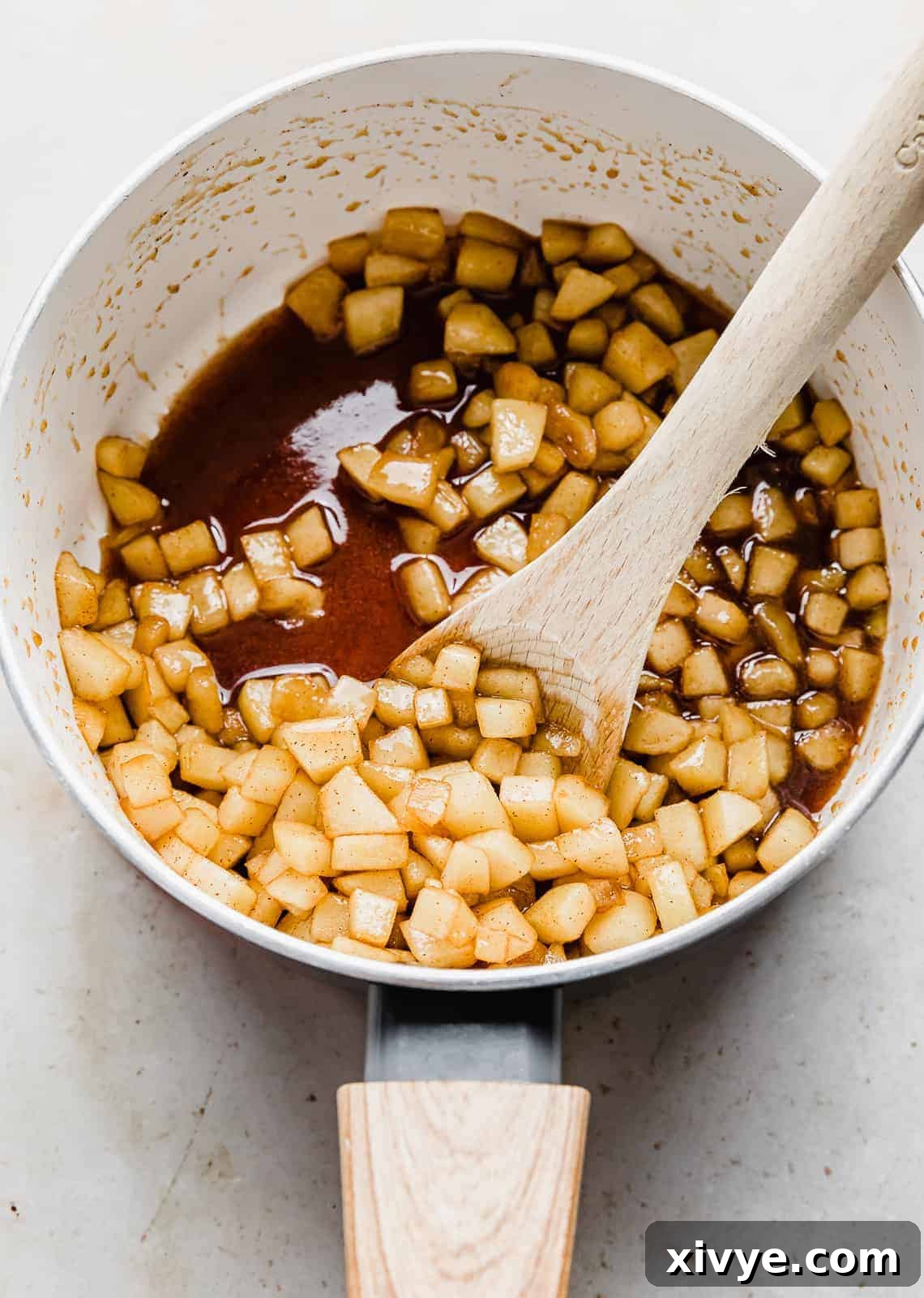 Cooked diced apples swimming in a sauce of brown sugar and cinnamon.