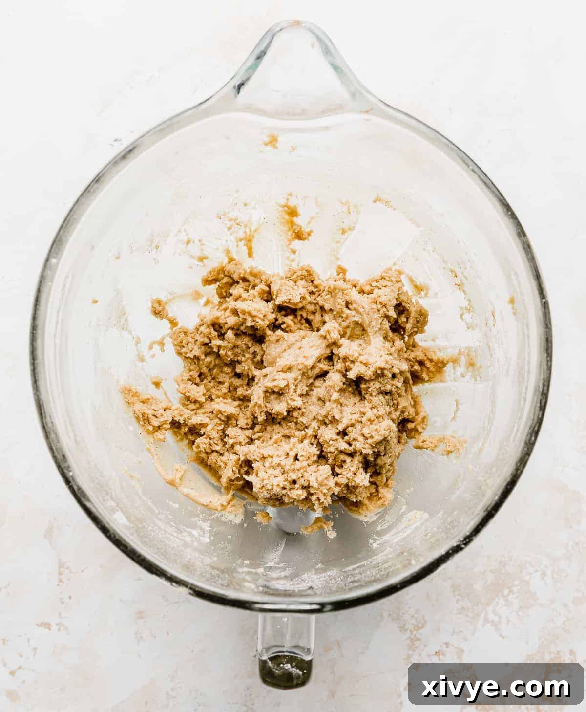 Gooey Caramel Apple Cookies 4 A glass mixing bowl with a caramel apple cookie dough in it.