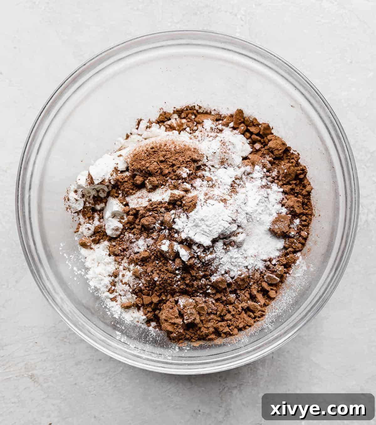 The dry ingredients for making Chocolate Doughnuts in a glass bowl.