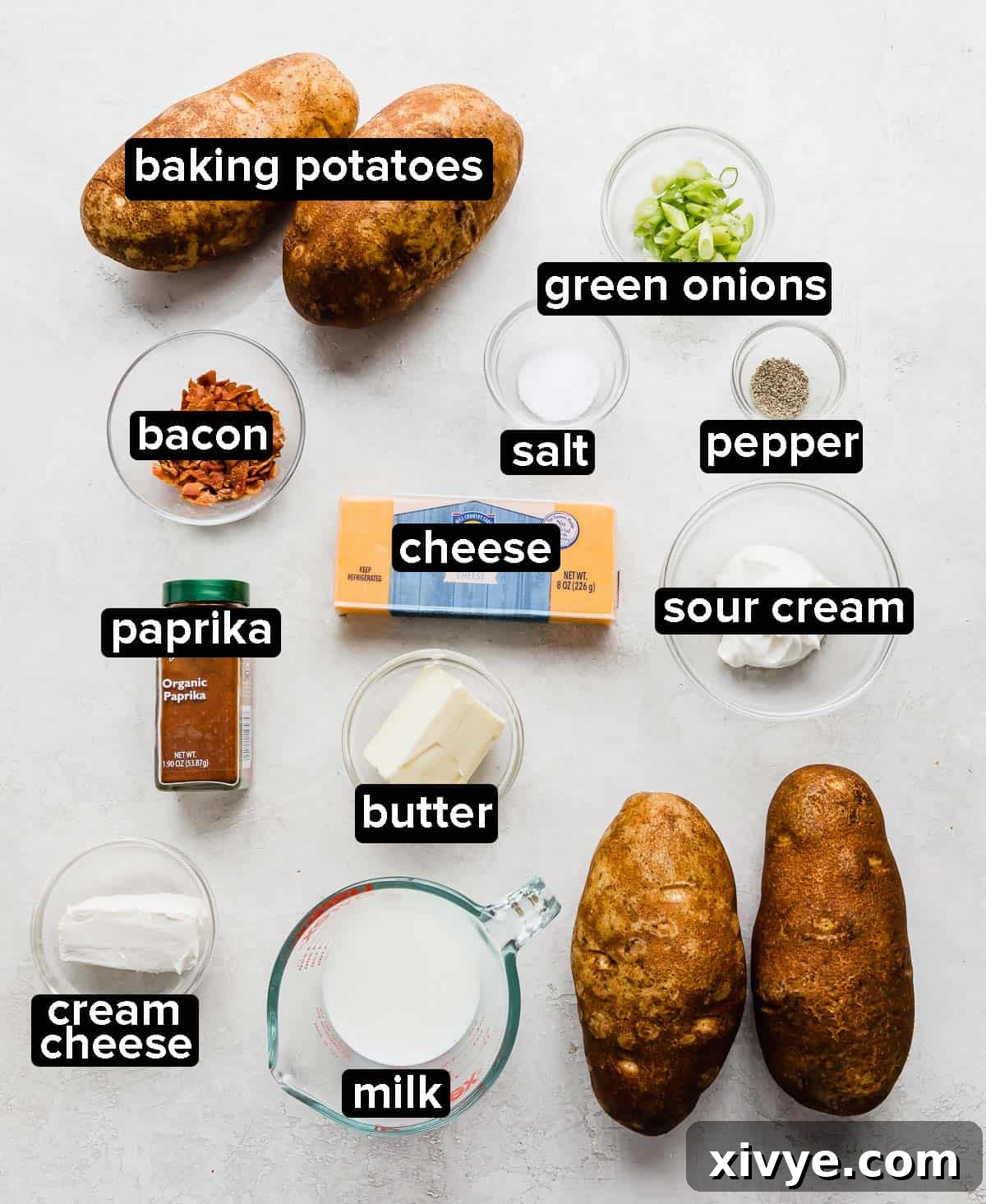 Decadent Double-Baked Potatoes 3 Twice Baked Potatoes with Cream Cheese on a gray background.