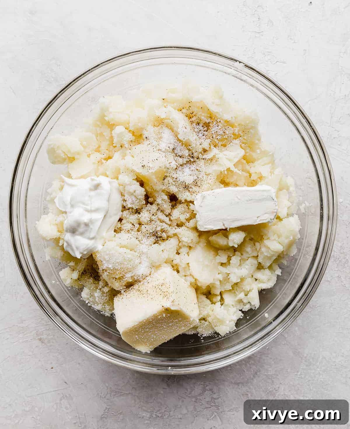 Decadent Double-Baked Potatoes 6 Potato pulp in a bowl with butter, cream cheese, and sour cream.