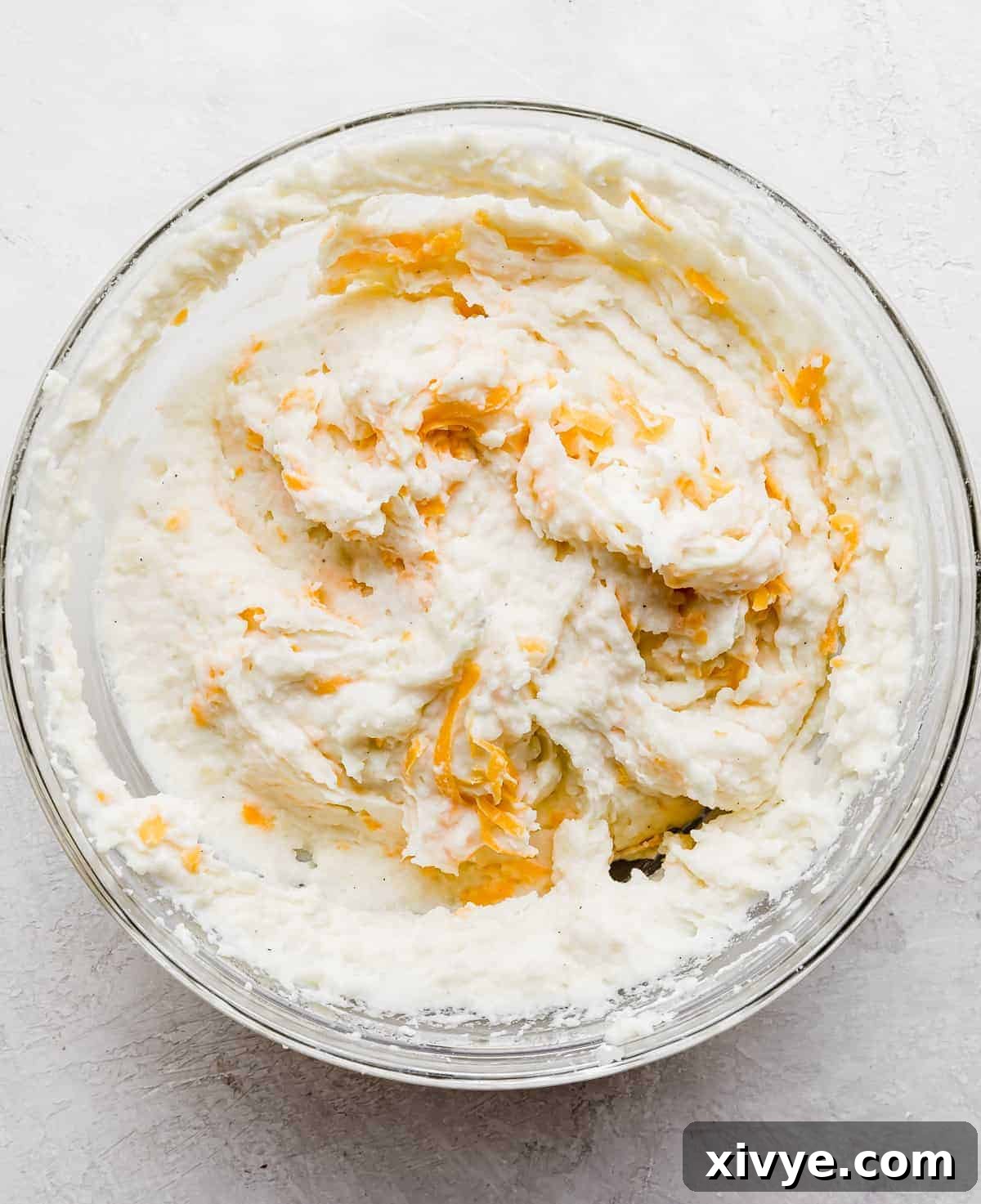 Decadent Double-Baked Potatoes 8 Mashed potatoes with shredded cheddar cheese stirred into it.