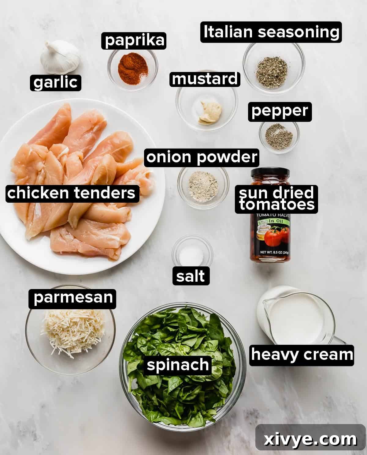 Creamy Tuscan Chicken ingredients on a gray background.