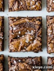 Nutella Brownies topped with sea salt on a white background.