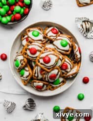 Yuletide Pretzel Bites 7 Red and green candy topped Christmas Pretzel Hugs on a white background.