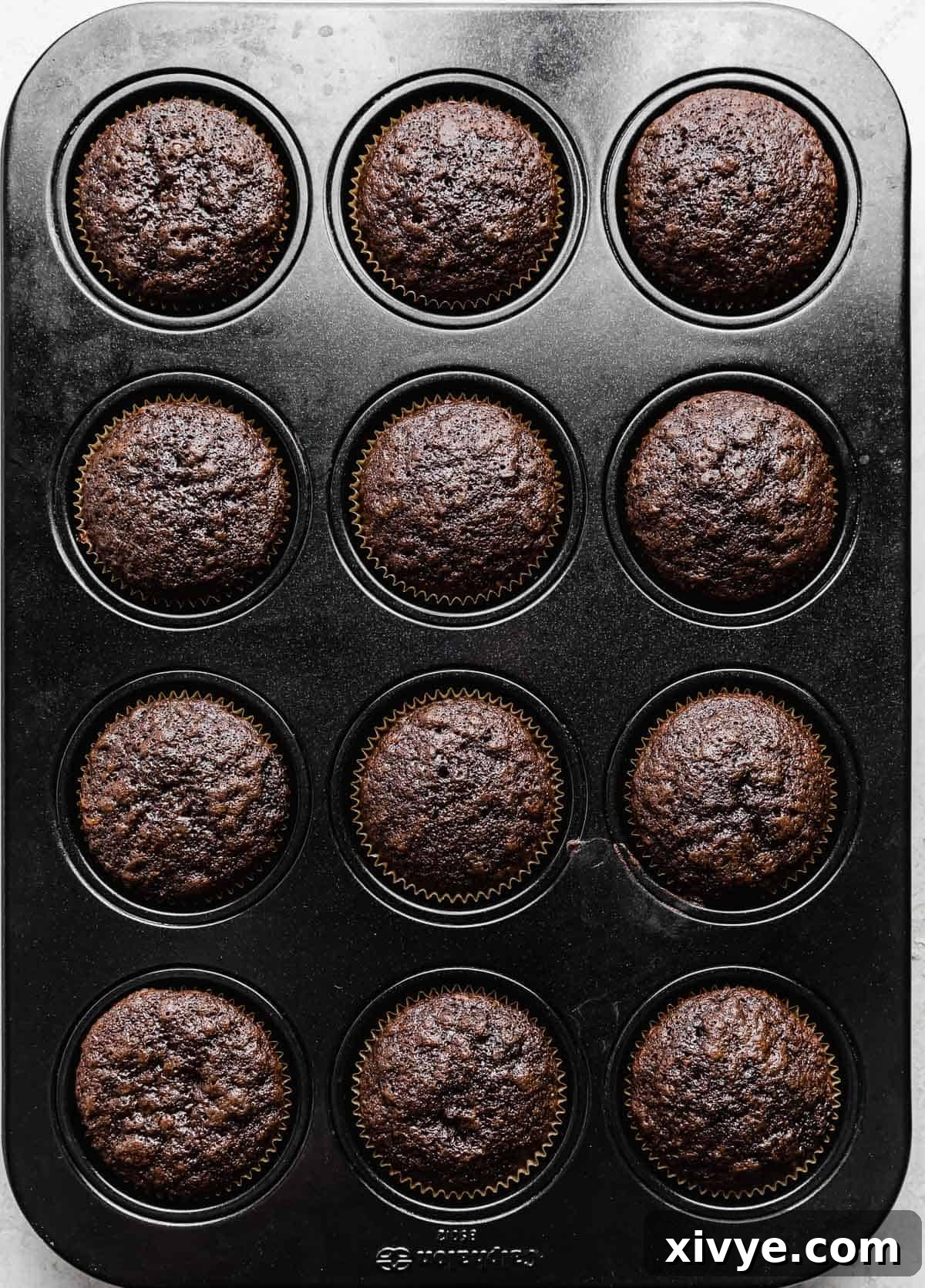 Baked Chocolate Orange Cupcakes in a twelve cupcake tin.