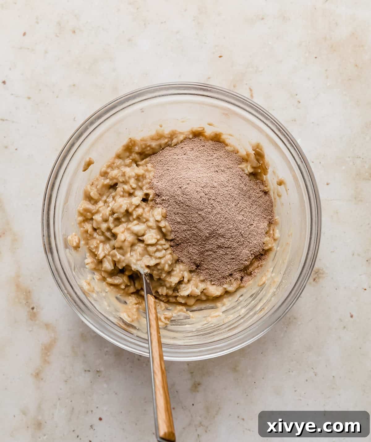 Peanut butter oatmeal with chocolate protein powder on top of it.