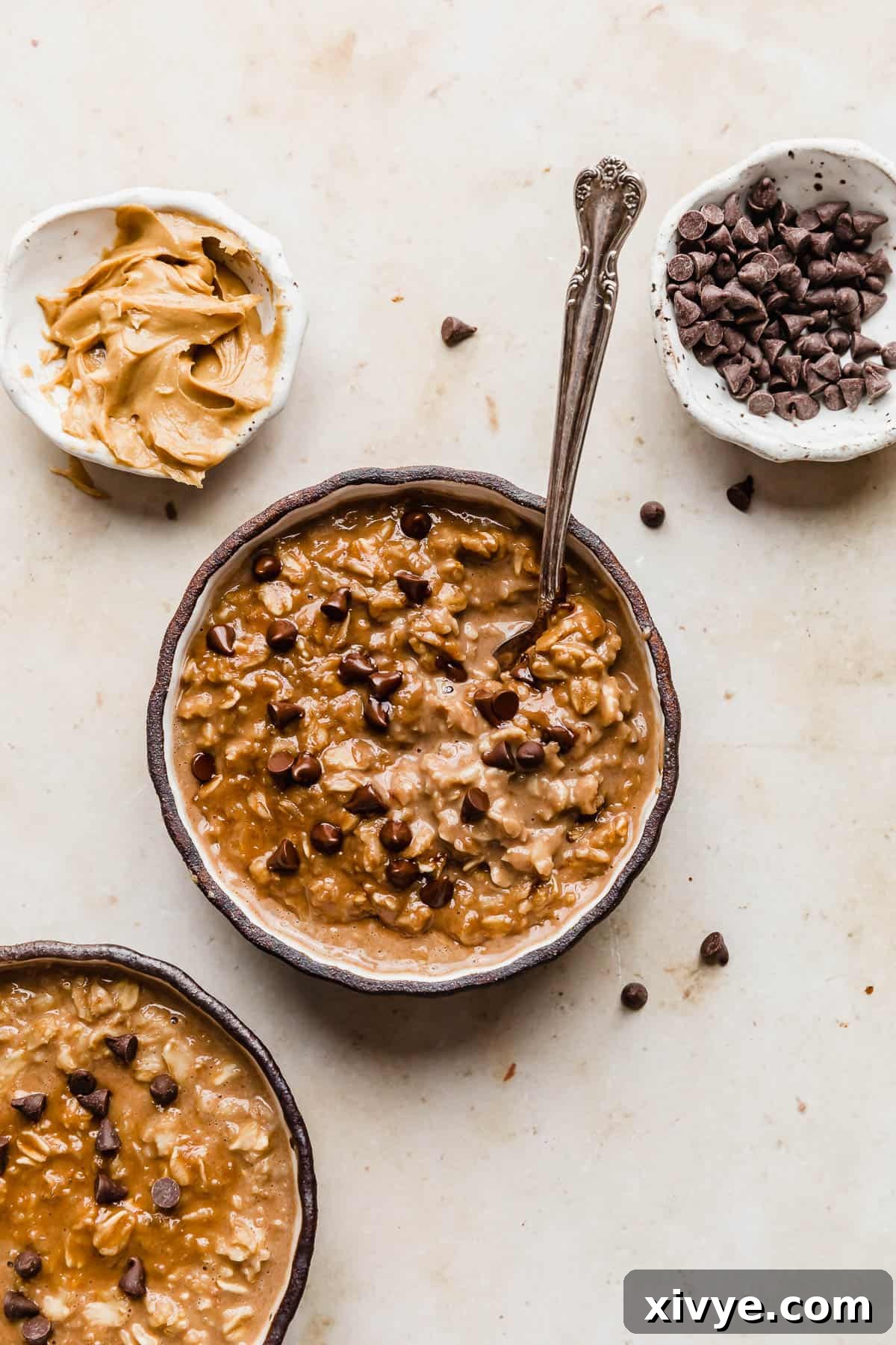 A black rimmed bowl full of Chocolate Peanut Butter Protein Oatmeal that is topped with mini chocolate chips.