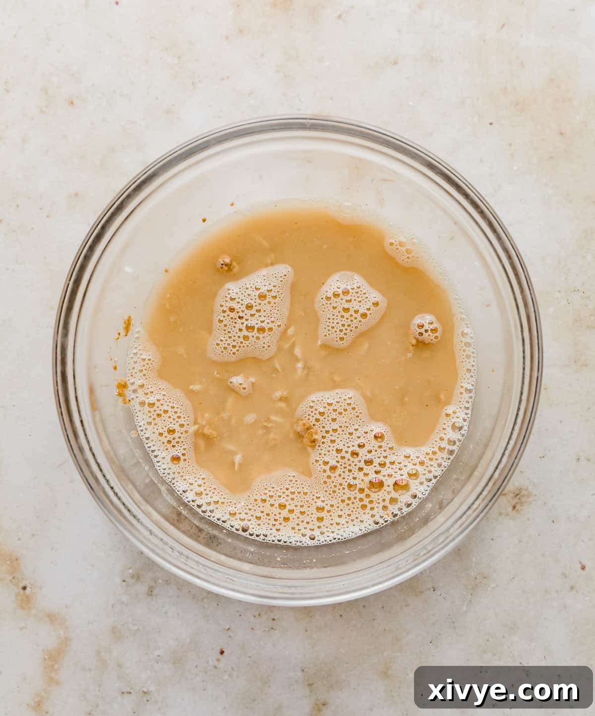 A glass bowl with water, oats, and pb fit in it.