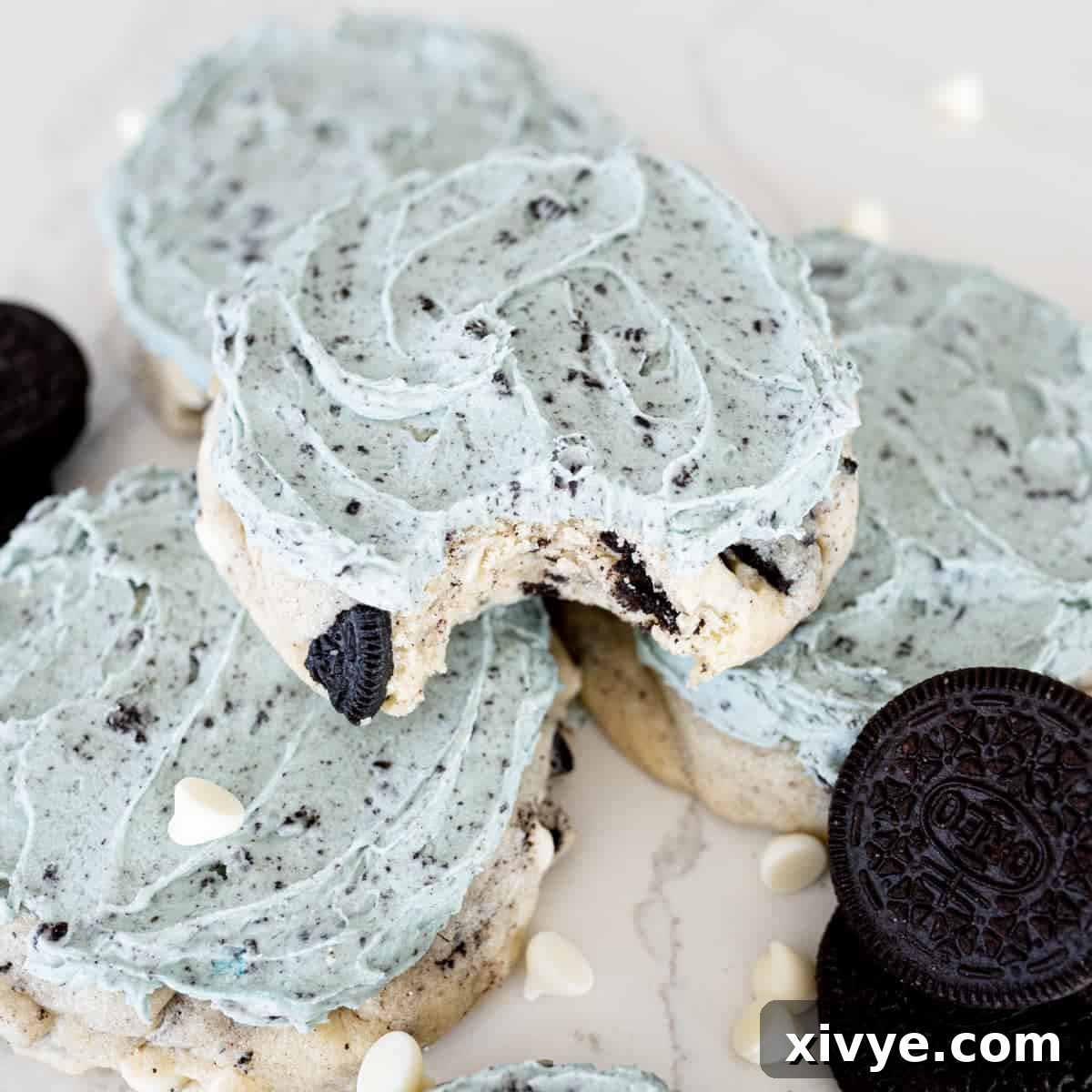A vibrant Aggie Blue Mint Cookie, a Crumbl copycat, featuring a minty chocolate Oreo base with a distinctive blue frosting, promising refreshing flavor.