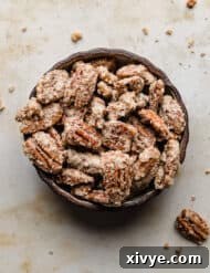 Sweet Glazed Pecans 13 Sugared Candied Pecans in a black bowl.