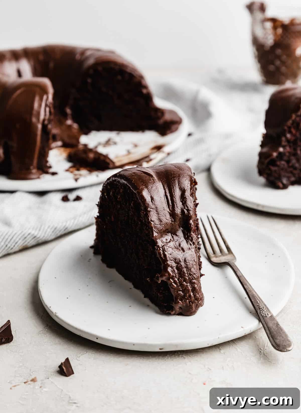 A slice of Chocolate Buttermilk Bundt Cake on a white plate.