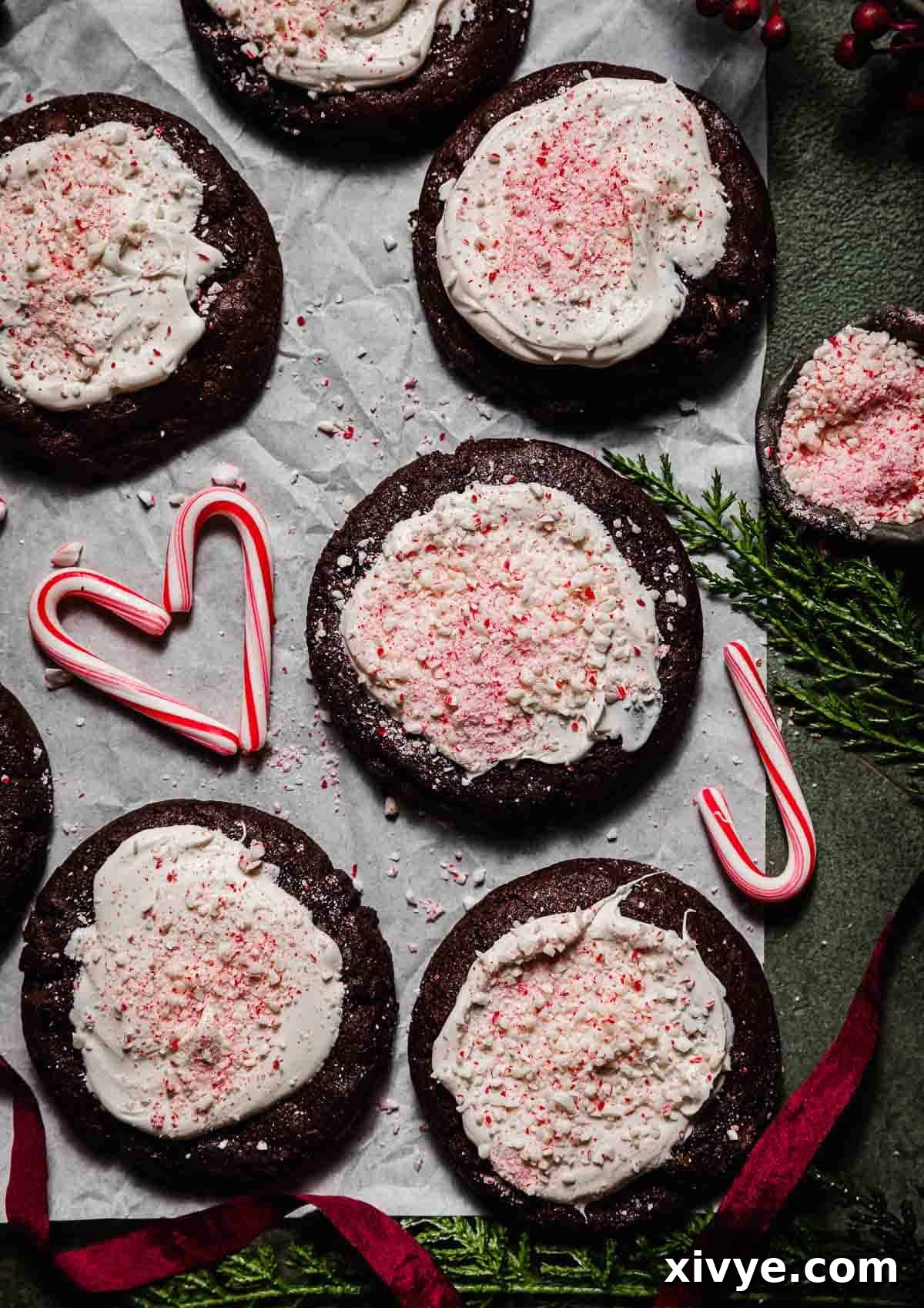 Peppermint Bark Bites 2 Overhead photos of chocolate Peppermint Bark Cookies topped with white chocolate and crushed candy canes, with faux pine needs around the border of the image.