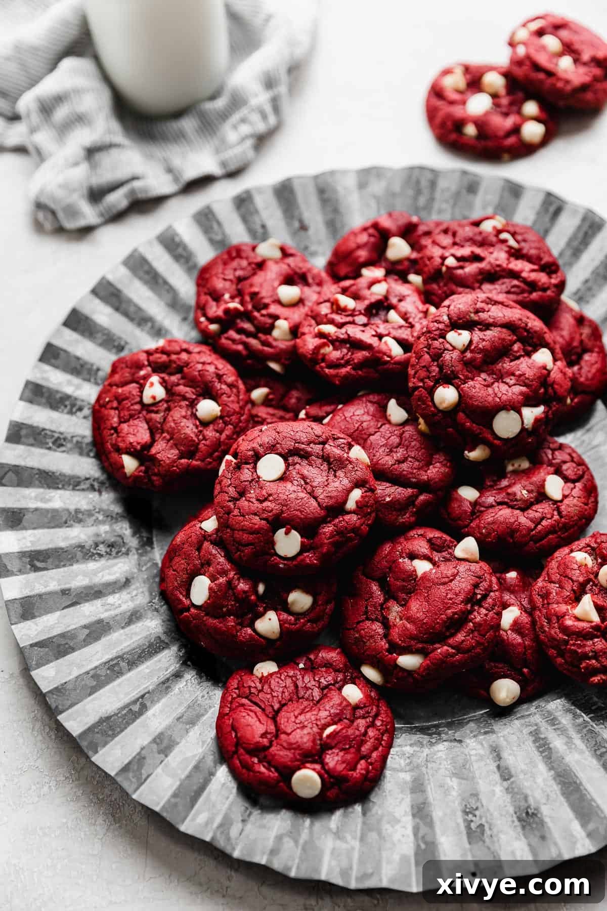 Red Velvet Cake Cookies 7 Red Velvet Cake Mix Cookies studded with white chocolate chips, on a metal fluted plate.