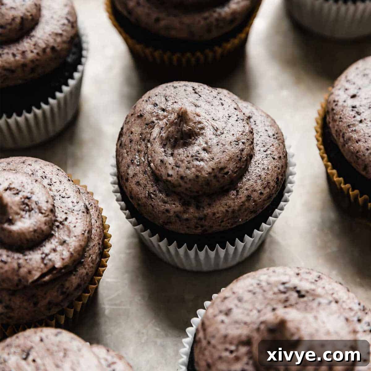 Irresistible Oreo Creations 11 A luscious swirl of Oreo Frosting beautifully piped onto a dark cupcake, highlighting its creamy texture and visible Oreo crumbs.