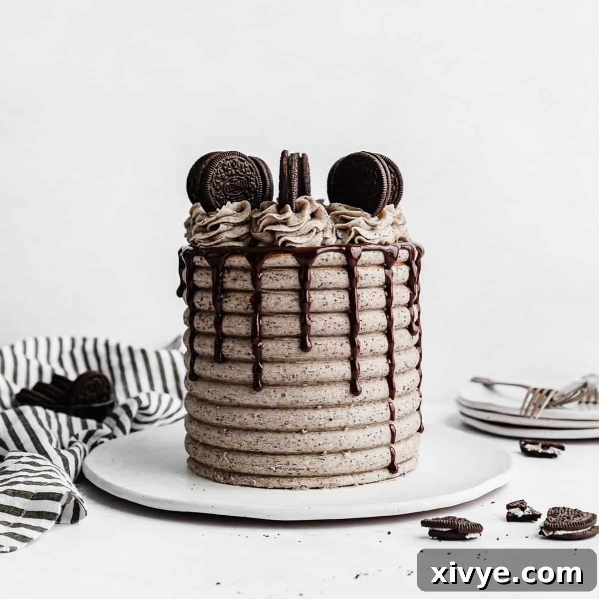 Irresistible Oreo Creations 21 A beautifully decorated Coconut Cookies and Cream Cake resting on a white plate, set against a pristine white background, showcasing its inviting layers.
