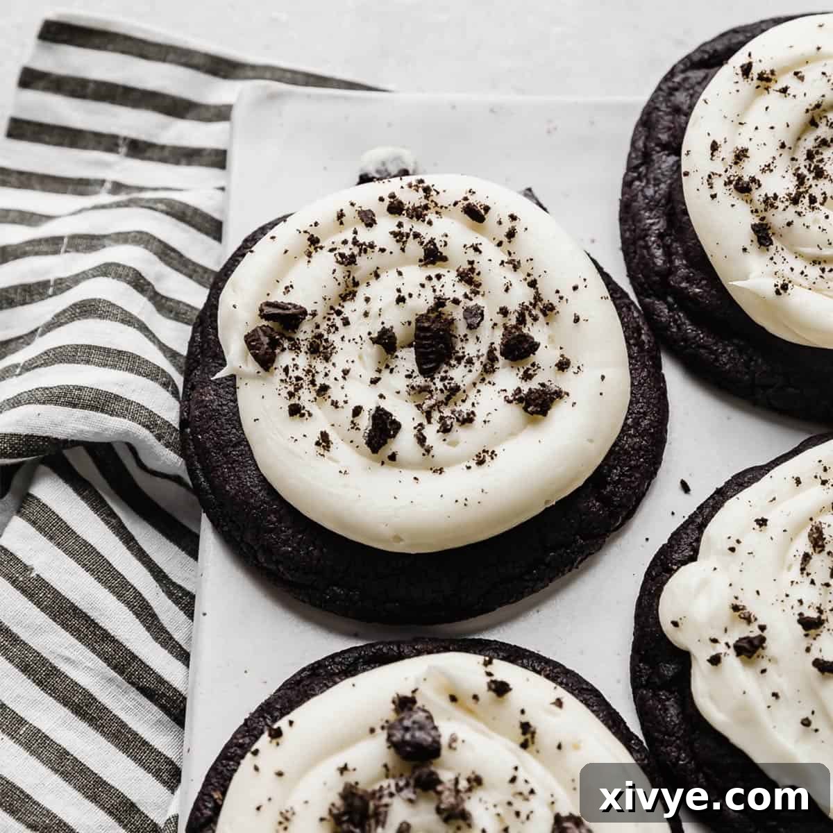 Irresistible Oreo Creations 7 A magnificent Crumbl Copycat Chocolate Oreo Cookie resting on a pristine white plate, showcasing its generous size and creamy frosting.