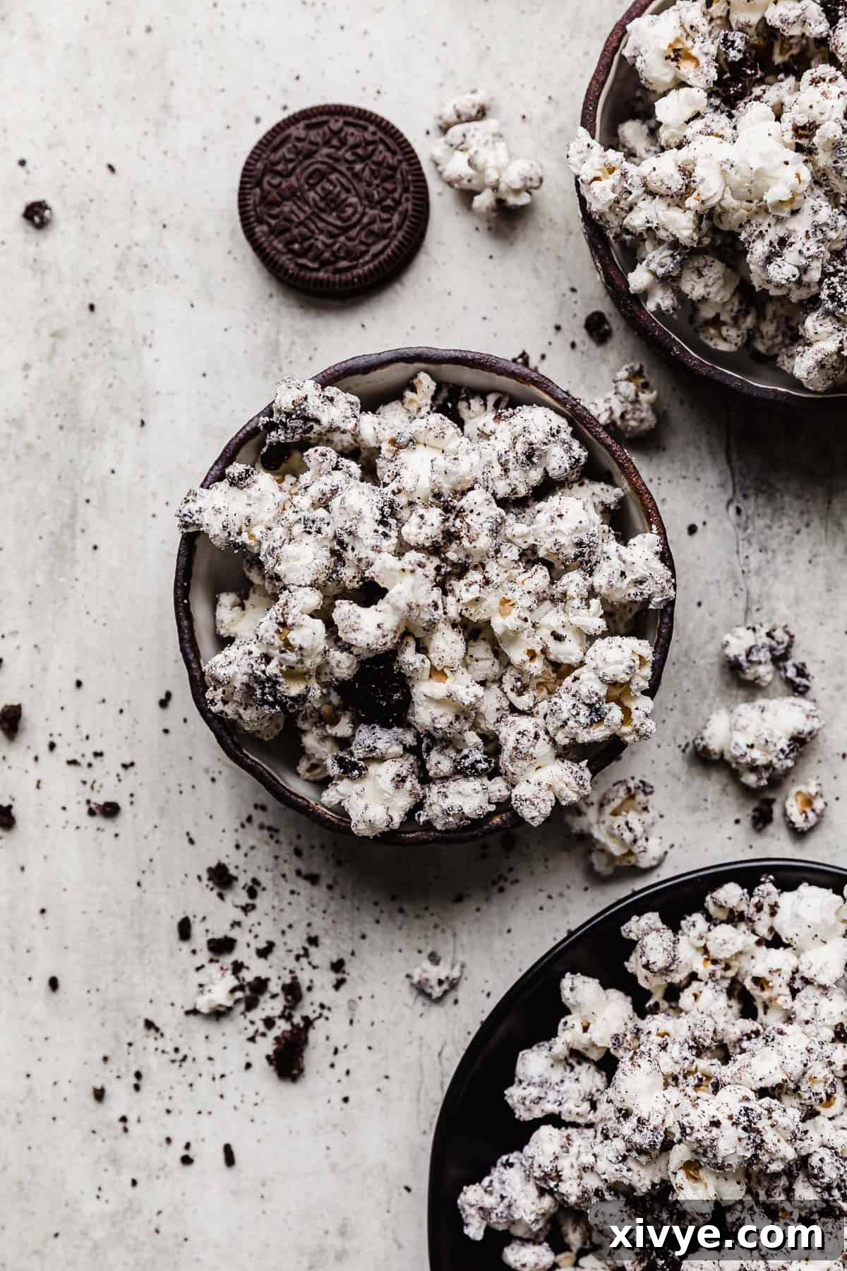 A large bowl brimming with sweet and salty Oreo Popcorn, featuring white chocolate coating and generous cookie crumbs.