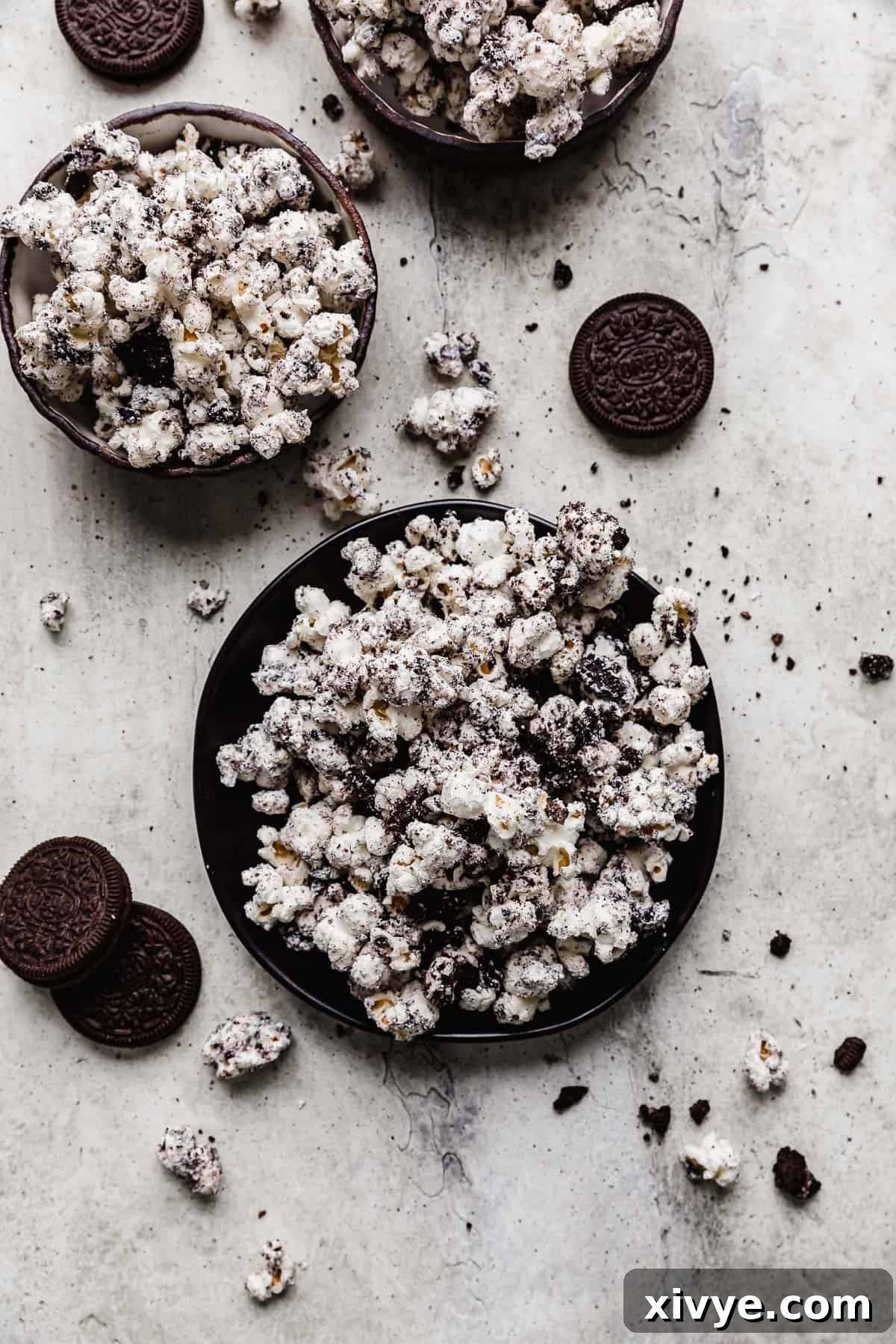 A perfectly portioned serving of Oreo Popcorn on a sleek black plate, showcasing its appealing texture and dark cookie crumbles.