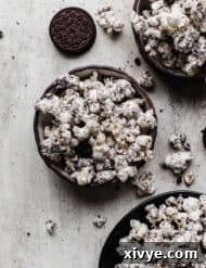 Irresistible Oreo crumbs and white chocolate covered popcorn in a black bowl, ready to serve.