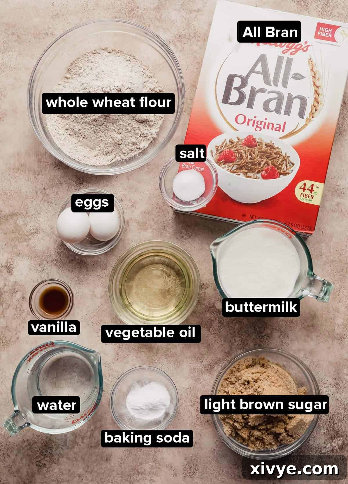 Hearty Buttermilk Bran Muffins 3 All Bran Muffins ingredients portioned into glass bowls on a beige textured background.