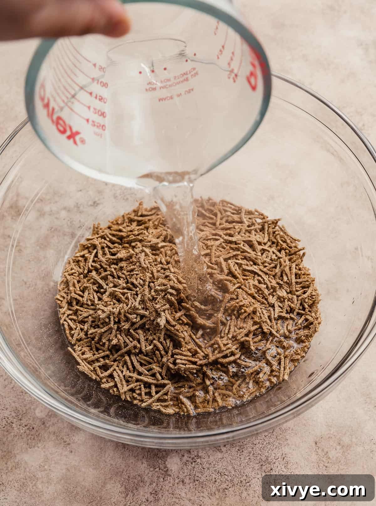 Hearty Buttermilk Bran Muffins 4 Hot water being poured overtop all bran.