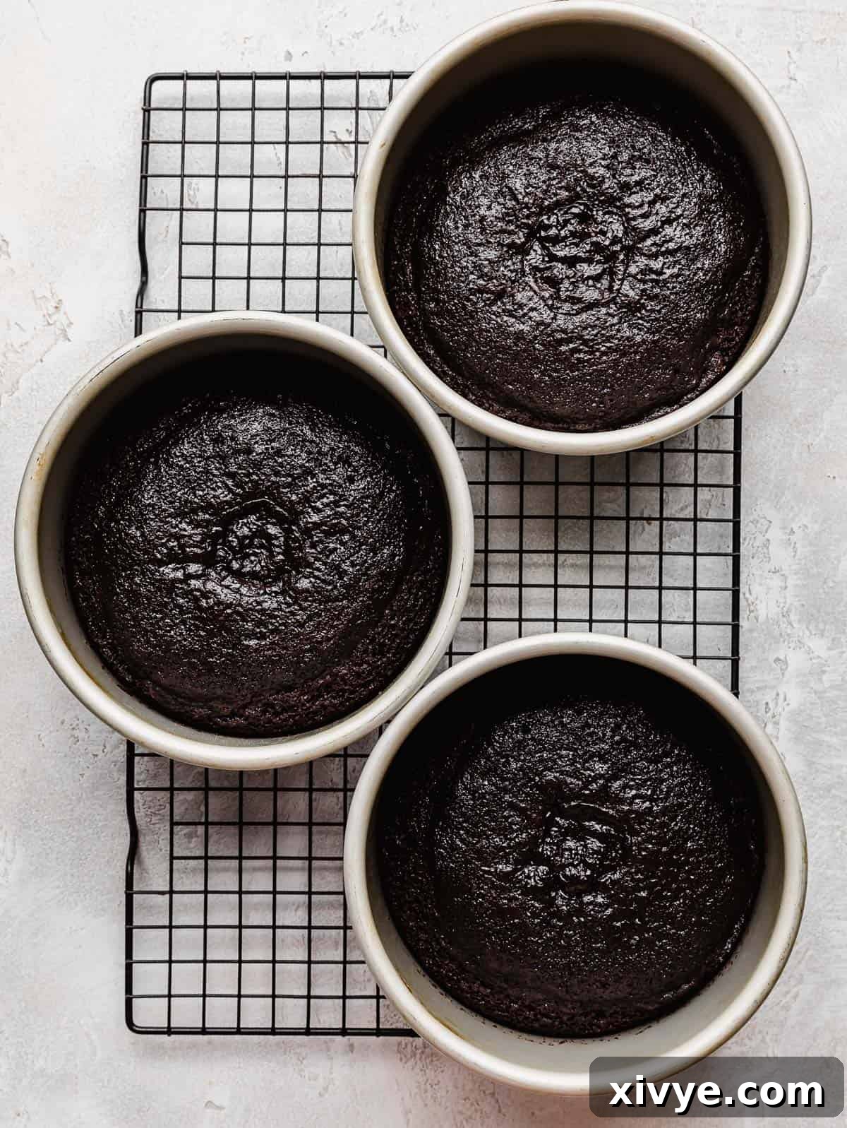 Three perfectly baked 6-inch German chocolate cake layers, removed from their pans and cooling on a wire rack.