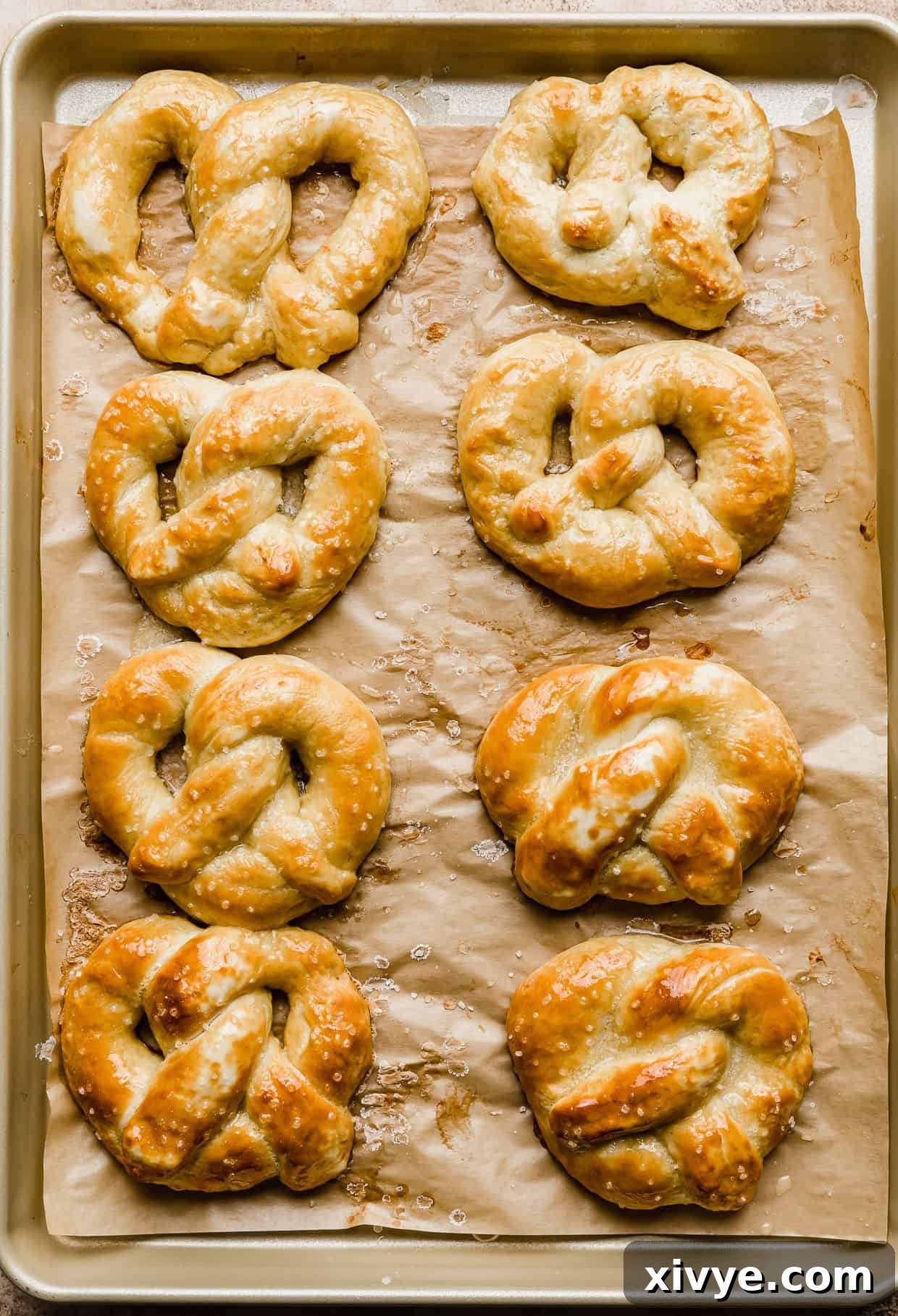 Pillowy Homemade Soft Pretzels 11 Baked Homemade Soft Pretzels on a baking sheet.