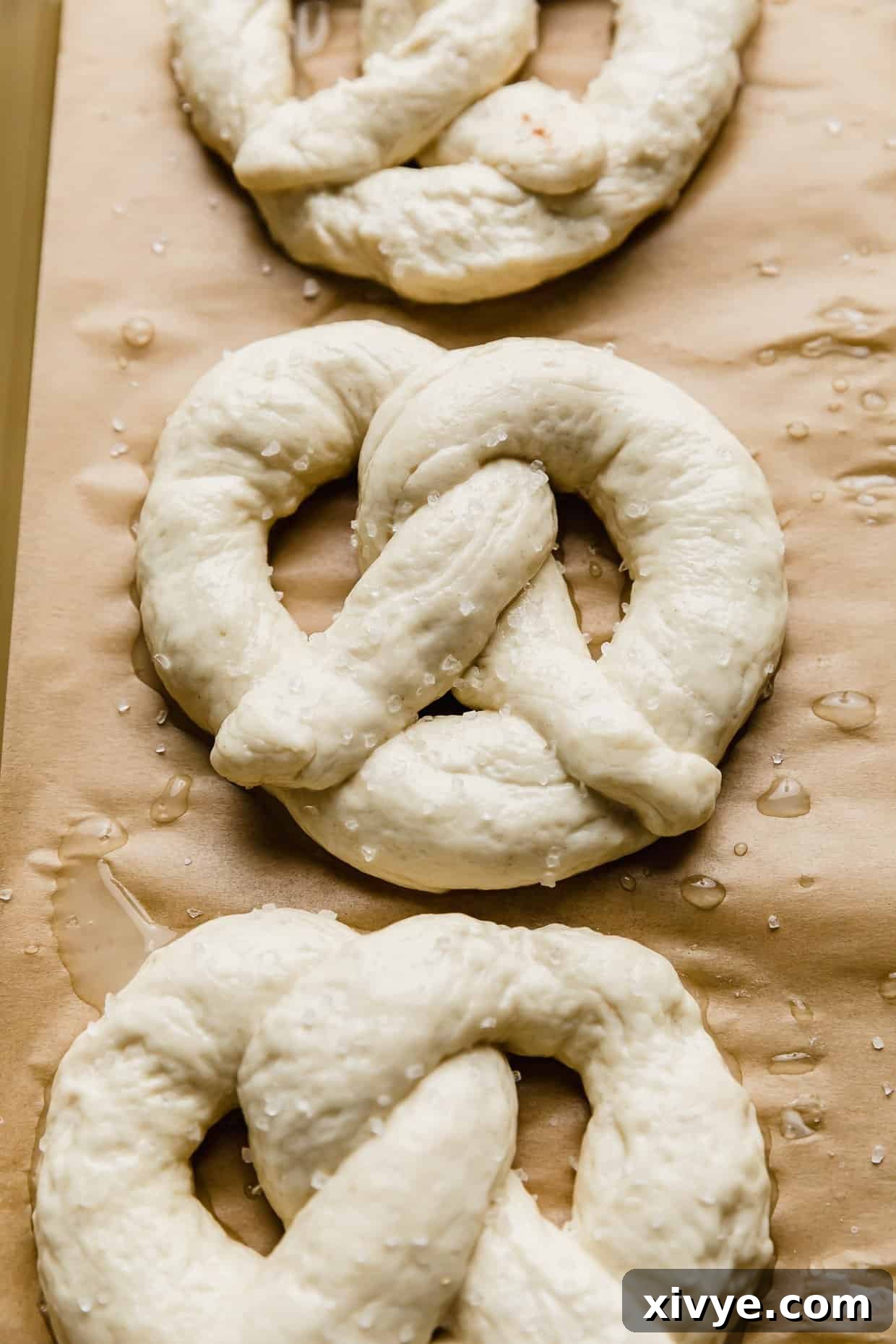Pillowy Homemade Soft Pretzels 8 A homemade pretzel on a baking sheet prior to baking