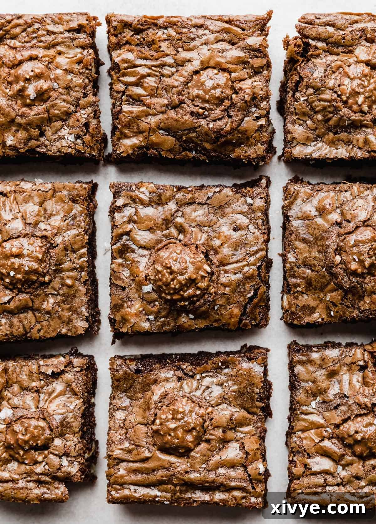 Overhead photo of Ferrero Rocher Brownies cut into squares with a Ferrero Rocher candy on top.