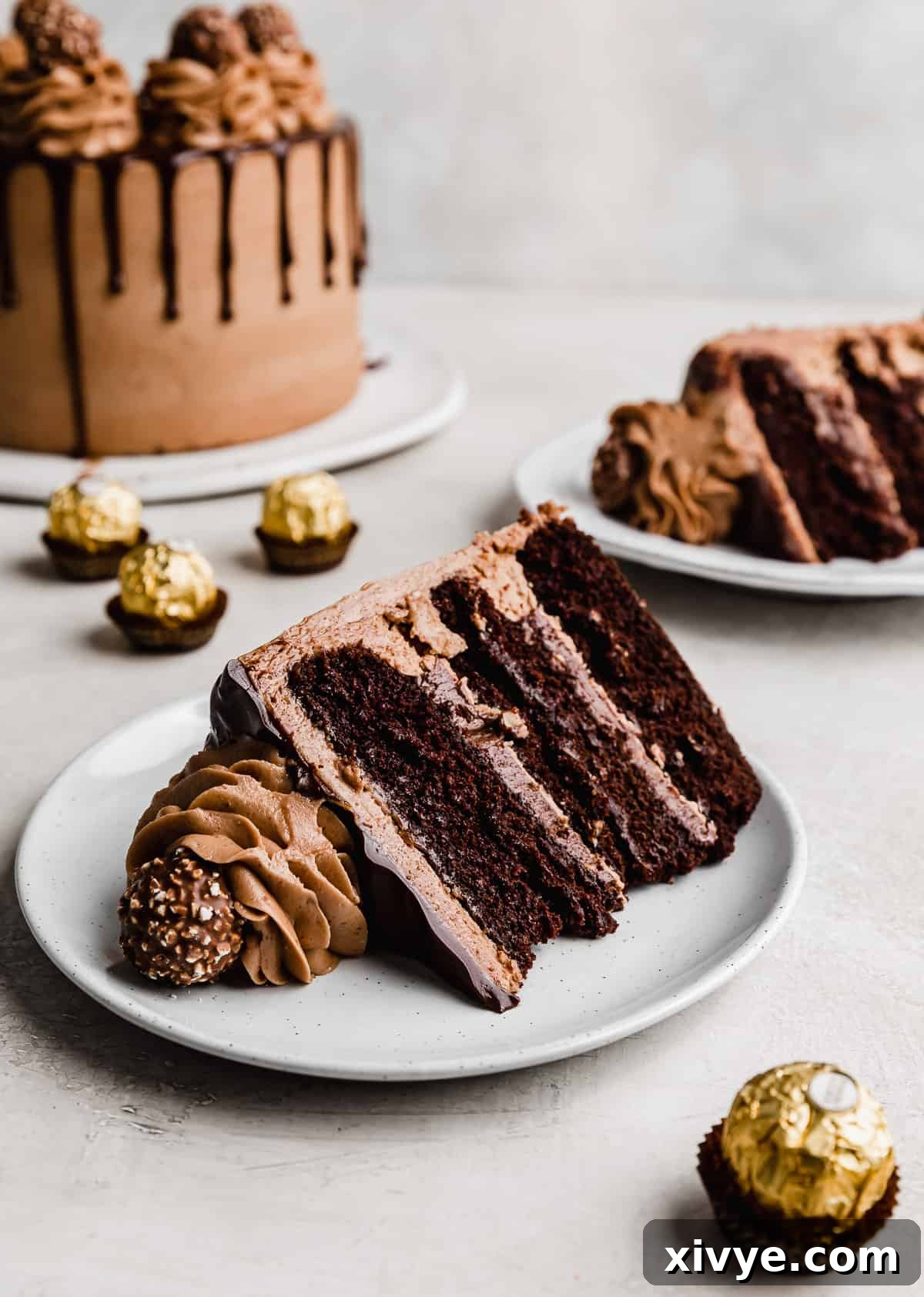 Ultimate Ferrero Rocher Indulgence 4 A slice of Ferrero Rocher Cake on a white plate against a white background.