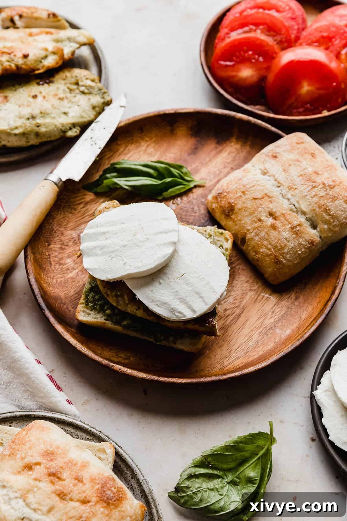 Gourmet Caprese Chicken Sandwich 6 A caprese sandwich with fresh mozzarella on top of grilled chicken, showing the creamy texture.