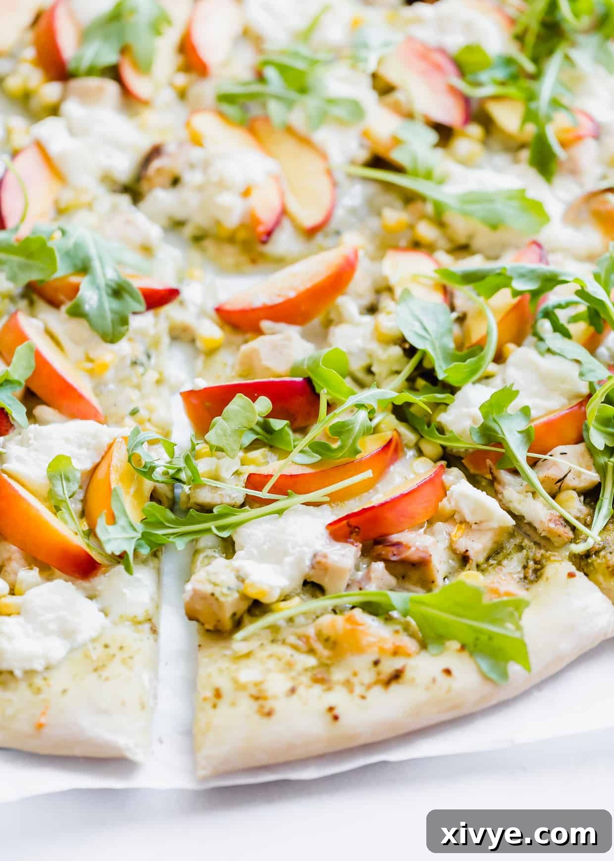 Peppery Rocket Pesto Pizza 6 Slice of pizza topped with ricotta, arugula, and nectarines.