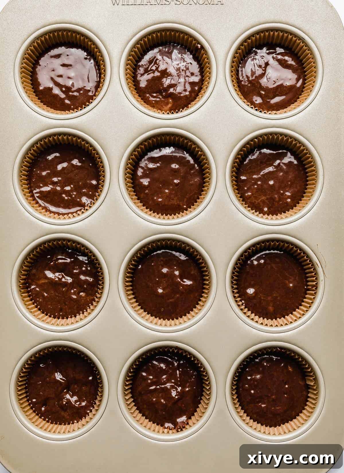 Chocolate hazelnut batter in cupcake lined muffin tin.
