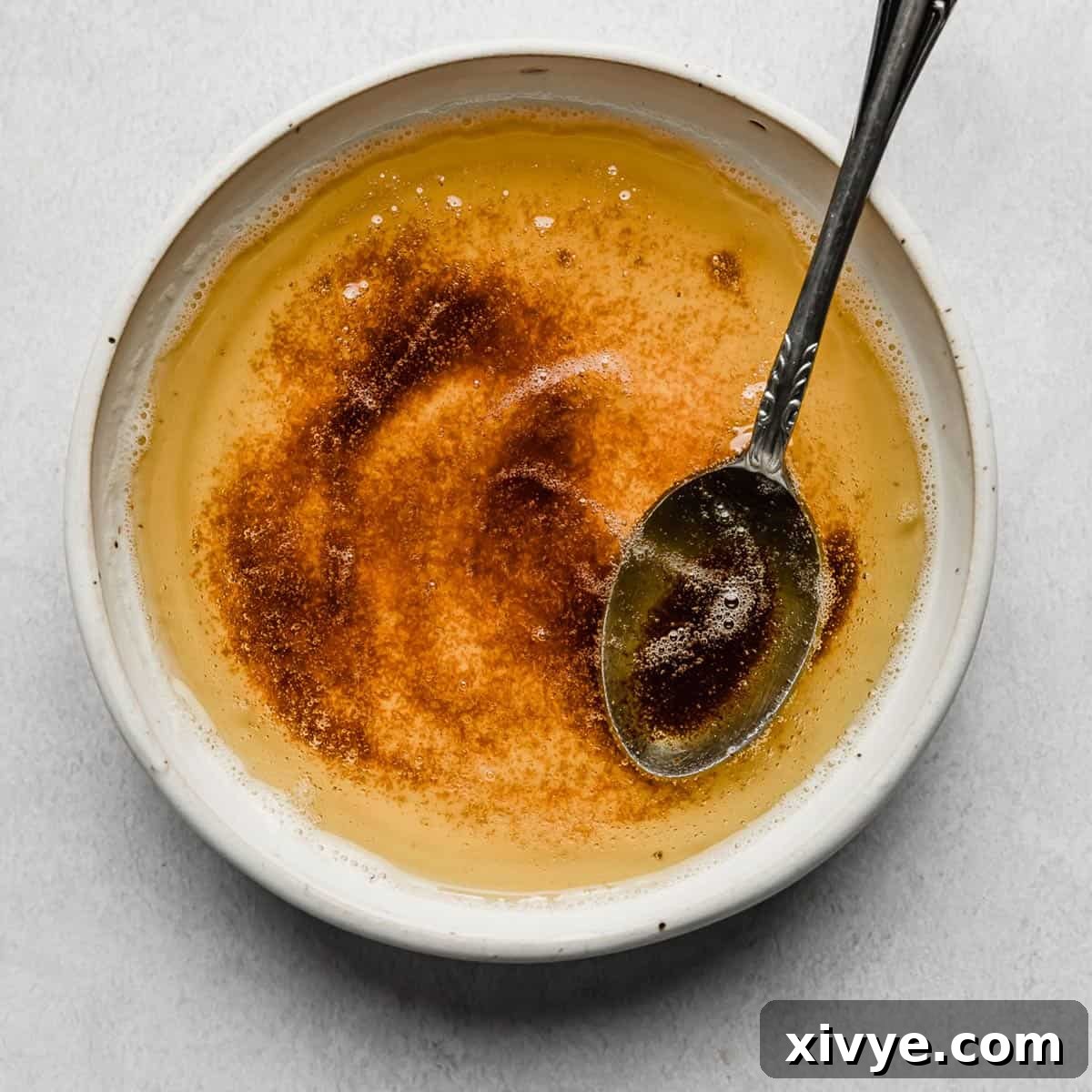 The Secret to Nutty Butter 8 A white bowl with browned butter in it, on a white background.