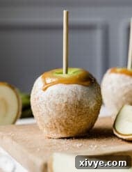 Caramel Apple Pie Fusion 14 A white chocolate and caramel dipped Rocky Mountain Apple Pie Caramel Apple against a light gray background.