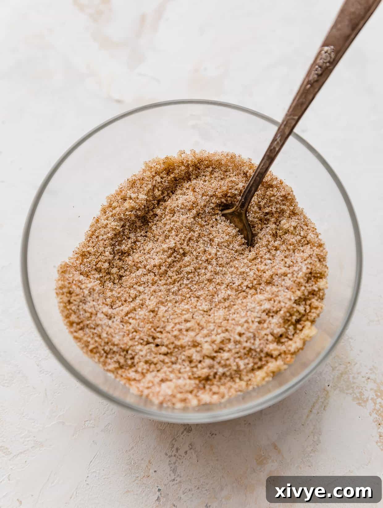 Caramel Apple Pie Fusion 5 A cinnamon sugar mixture in a glass bowl on a white background.
