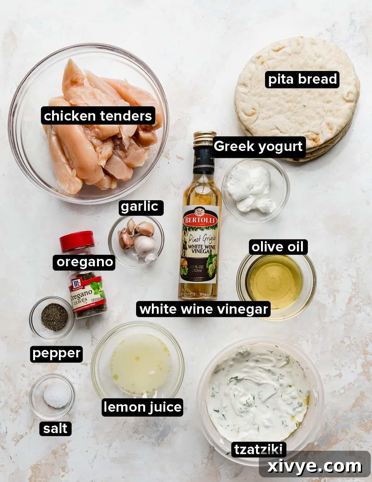 Greek Chicken Gyros ingredients on a white textured background.