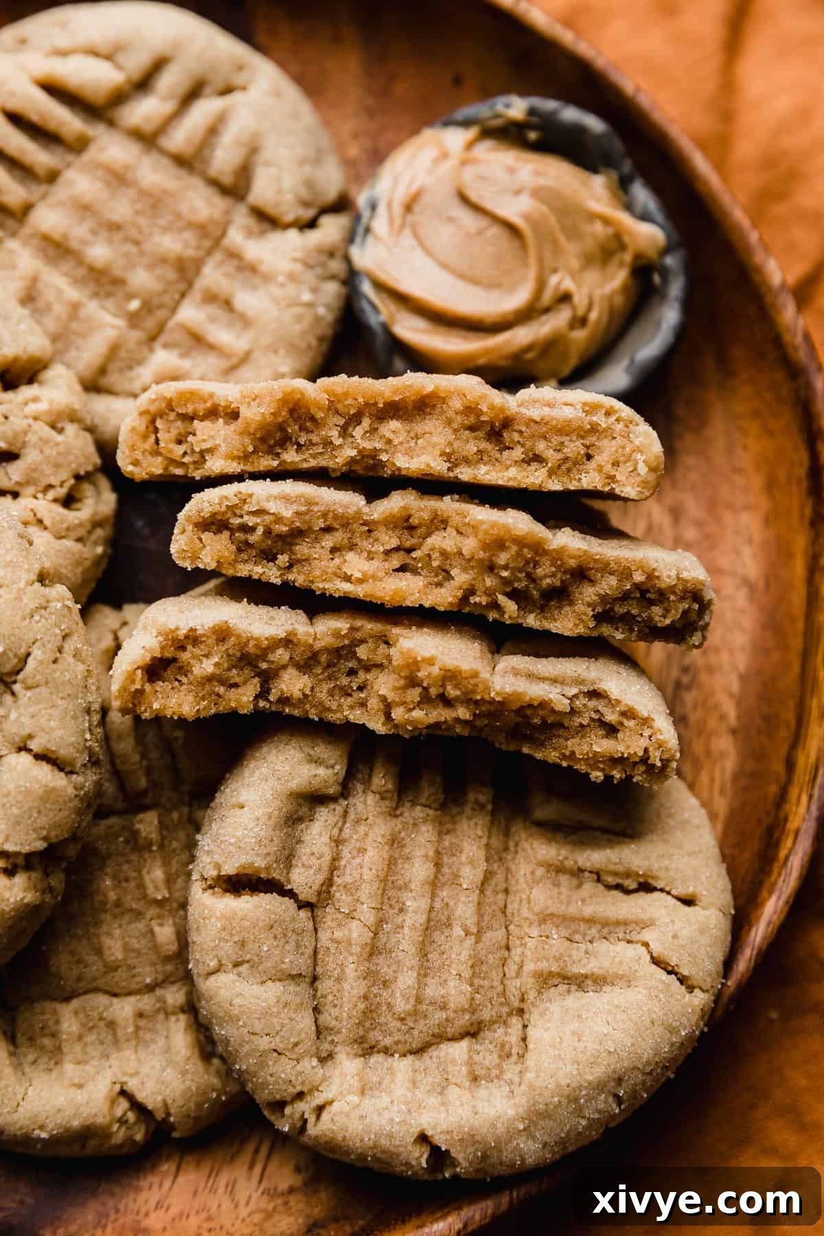 Crumbl's Iconic Peanut Butter Perfection 9 Classic peanut butter cookies torn in half on an orange plate.