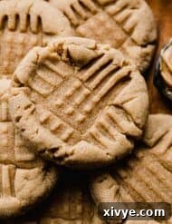 Crumbl's Iconic Peanut Butter Perfection 10 Close up photo of a classic Peanut Butter Cookie with fork tine criss crosses imprinted in the top of the cookie.