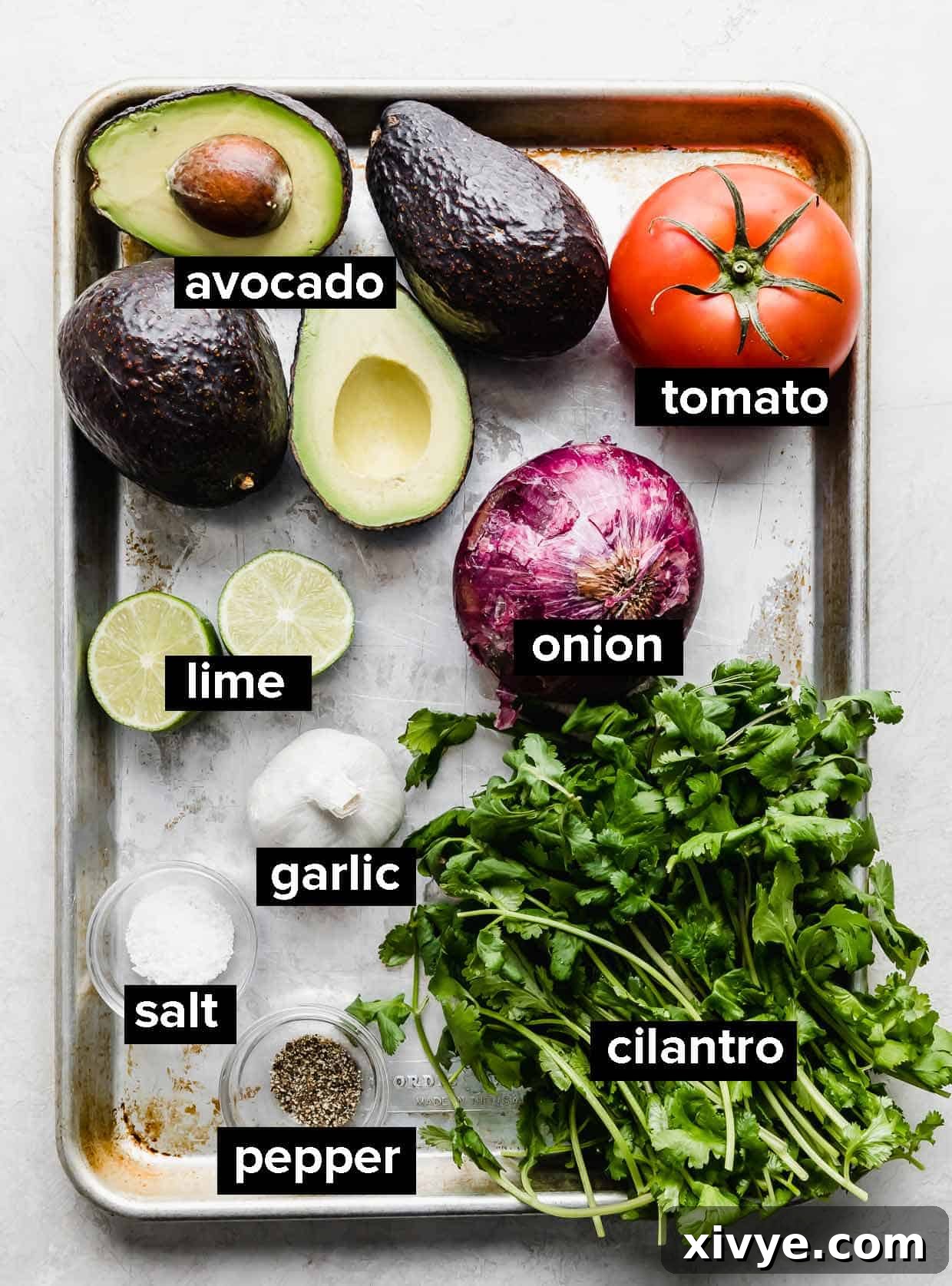 Guacamole ingredients on a baking sheet. 