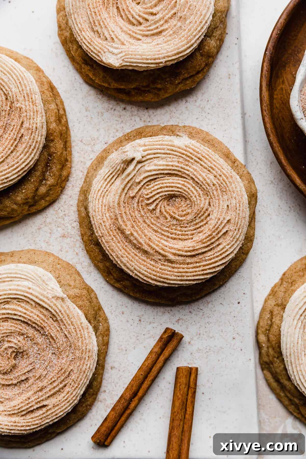 Homemade Crumbl Churro Cookie Perfection 2 A beautifully frosted Crumbl Churro Cookie, generously topped with sparkling cinnamon sugar, ready to be enjoyed.