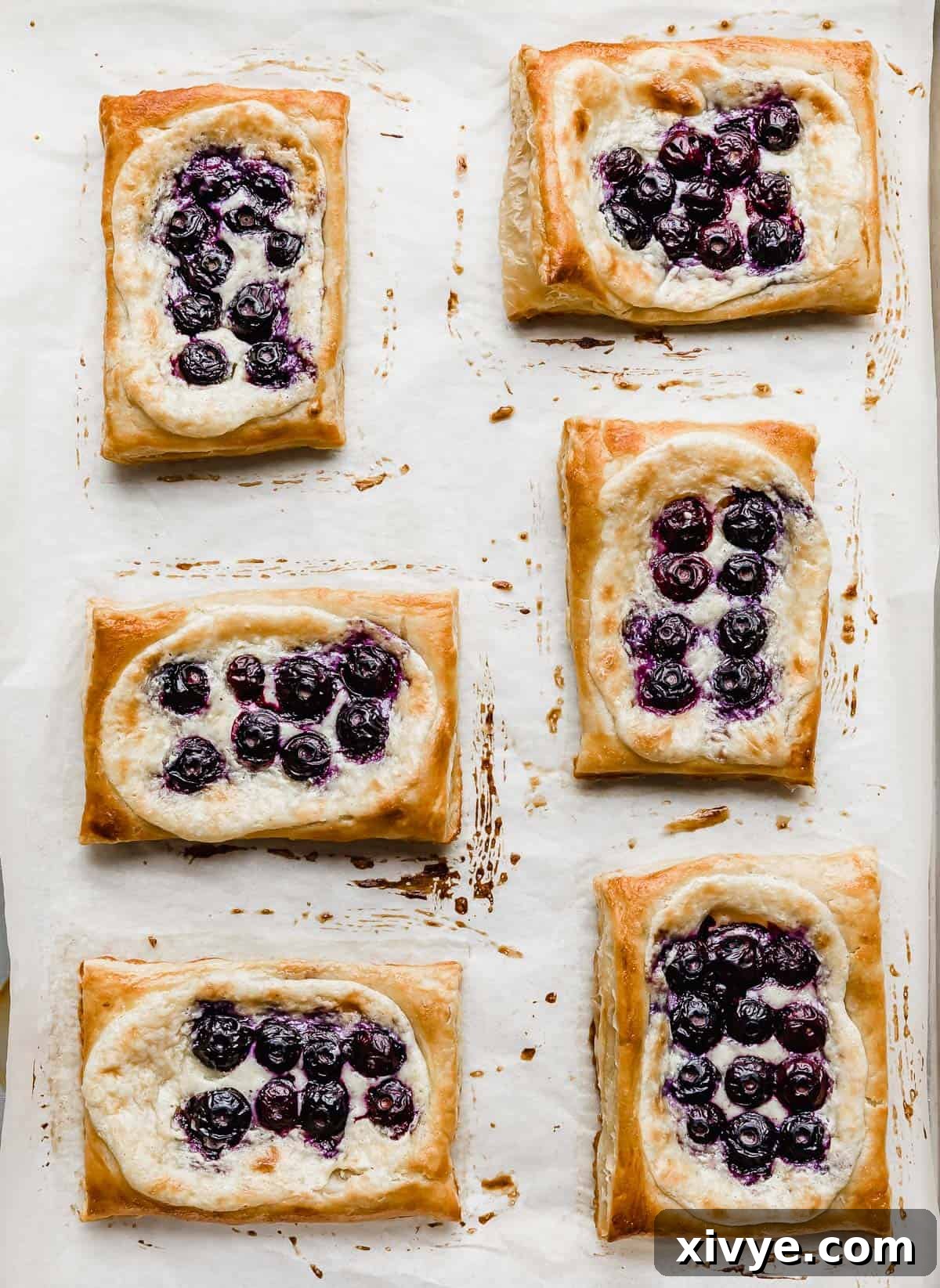 Flaky Blueberry Dream 9 Baked Blueberry Danish puff pastry on a baking sheet.
