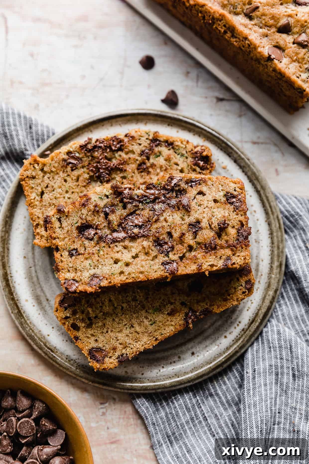 A slice of Chocolate Chip Zucchini Bread on a gray plate.