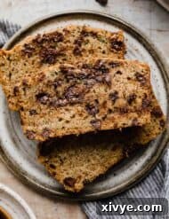 A slice of Chocolate Chip Zucchini Bread on a gray plate.