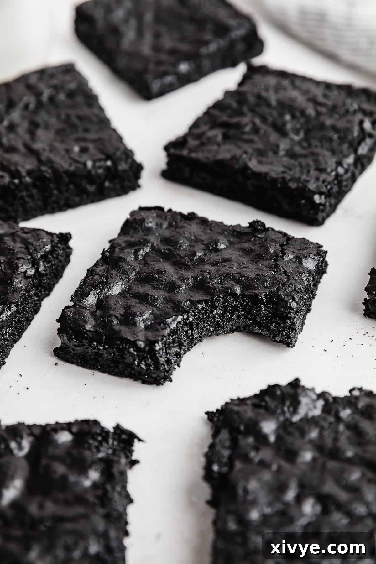 Ultimate Blackout Brownies 2 A square of Black Cocoa Brownies with a bite taken out of it, showcasing its rich, dark interior and fudgy texture.